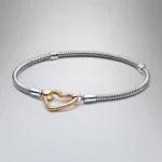 Ženska narukvica od srebra sa kopčom srce sa pozlatom na preklop